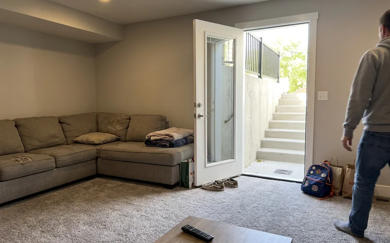 Basement living space with walkout door open to the stairwell