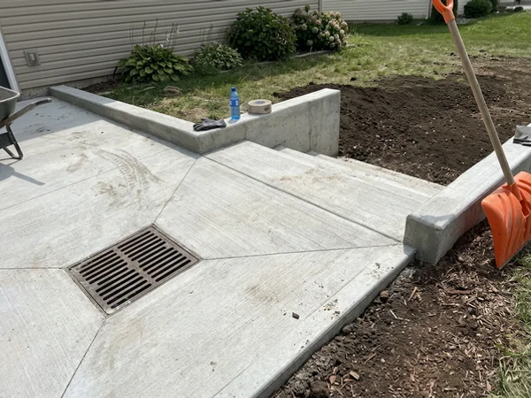 Illustration of a new landing sloped to an accessible catch basin