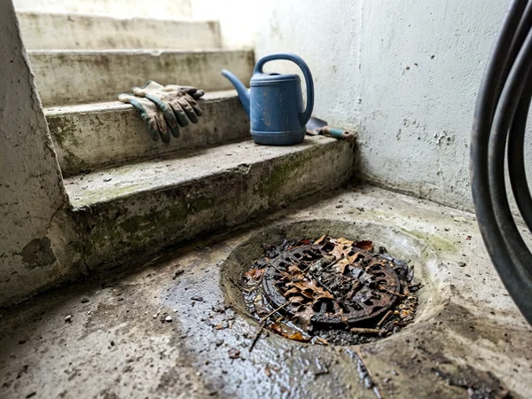 Illustration of a small clogged floor drain in an old walkout
